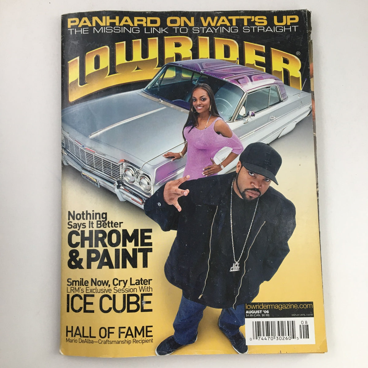Cover of LowRider Magazine August 2006 featuring Ice Cube and a lowrider car. The magazine highlights LRM's exclusive session with Ice Cube and showcases a vibrant photo emphasizing the lowrider culture.