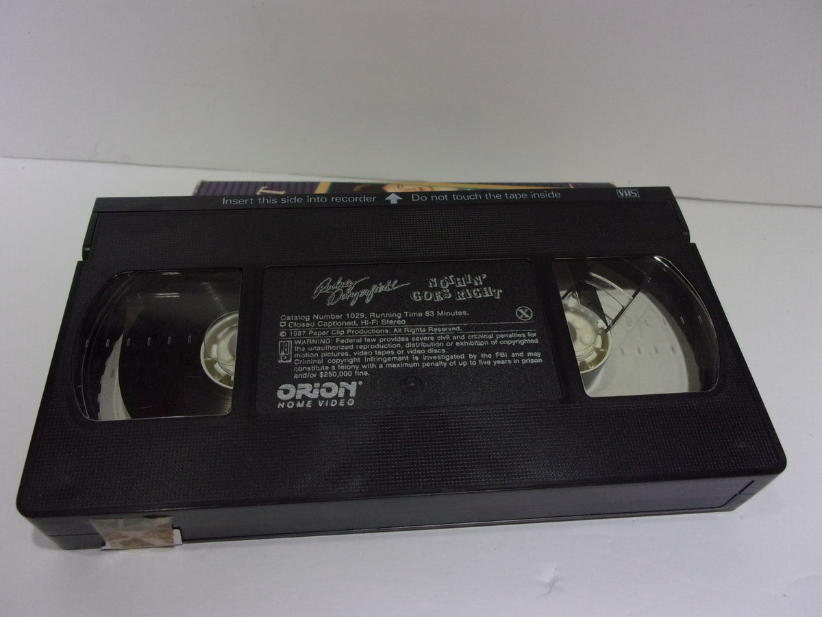 Inside view of Nothin' Goes Right Rodney Dangerfield VHS tape, showing the cassette itself.