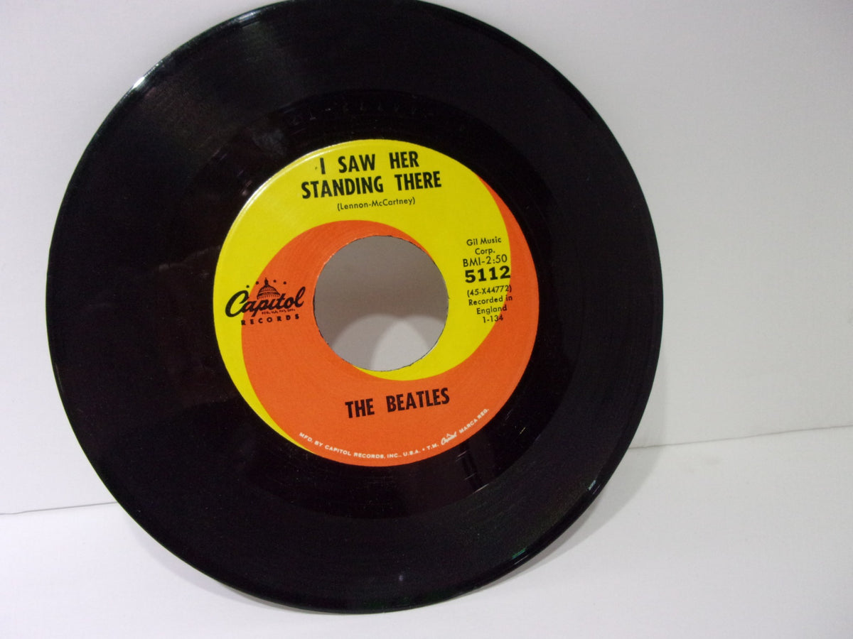 The Beatles: I Want To Hold Your Hand Capitol Records 5112 45RPM Single 7" showing the record label with the song 'I Saw Her Standing There'.