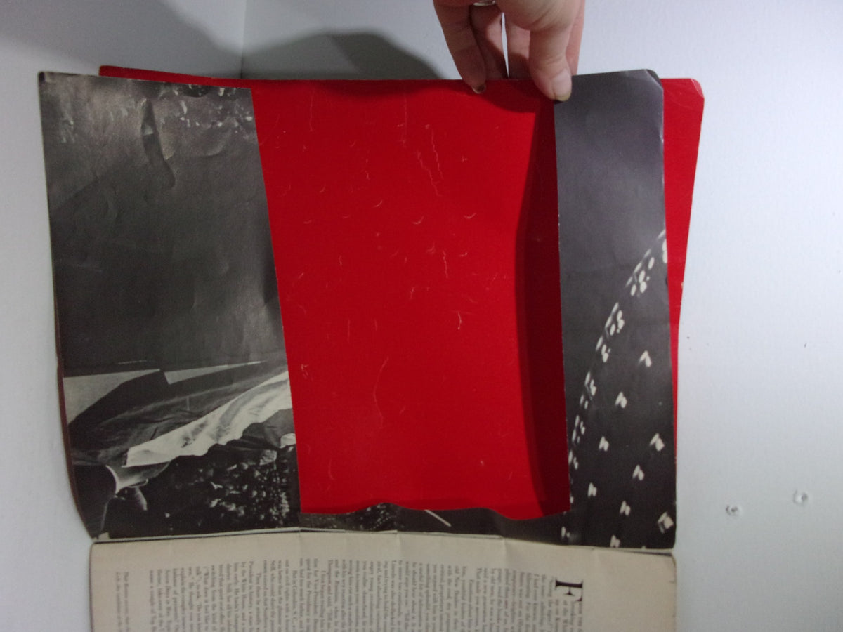 Inside view of the 1964 Look Magazine: JFK Memorial Book showing a red cover partially opened with black and white photographs.