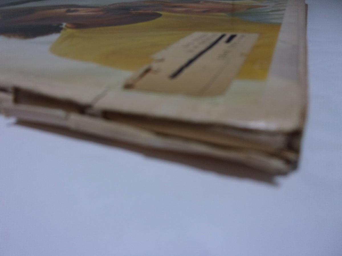 Close-up view of the worn spine of Look Magazine: The JFK Memorial Issue, dated November 17, 1964, showing signs of age and a unique vintage charm.