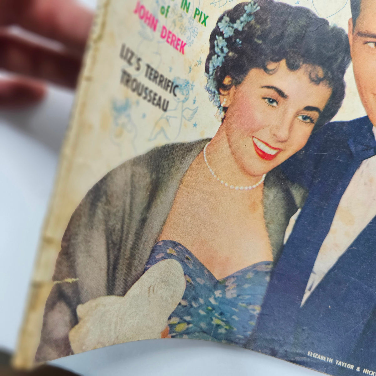 Cover of VTG Movie Life Magazine from July 1950 featuring Elizabeth Taylor and Nicky Hilton, showcasing Hollywood glamour and vintage style.