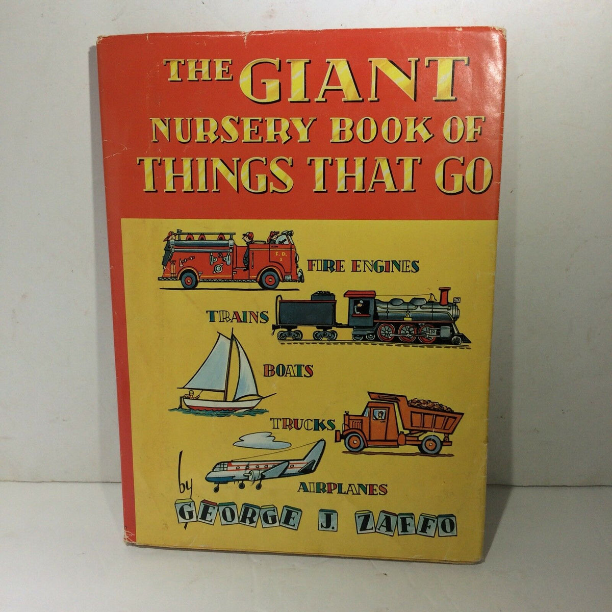 Cover of The Giant Nursery Book of Things That Go by George Zaffo featuring illustrations of fire engines, trains, boats, trucks, and airplanes.