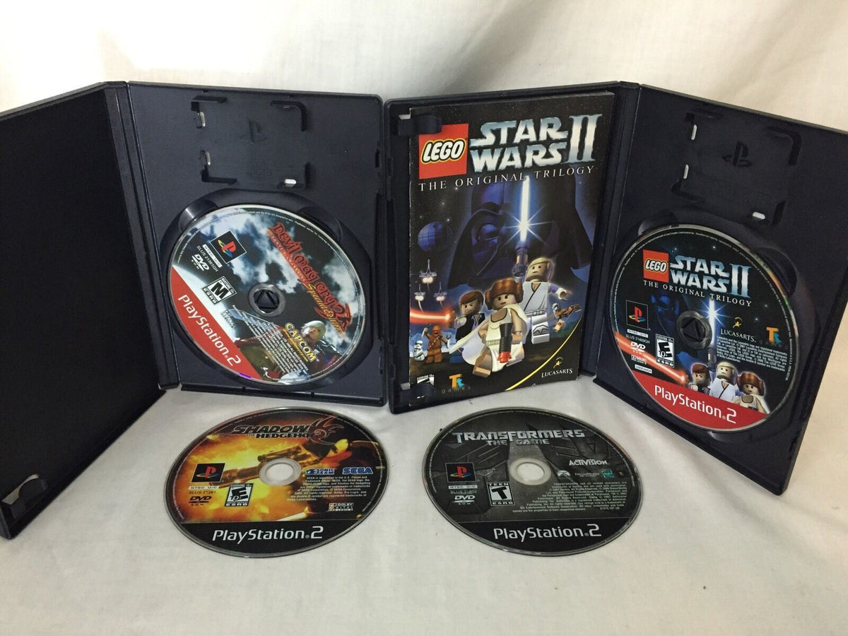 Inside view of PlayStation 2 case showing Lego Star Wars II and other game discs, part of the collection 4 Devil May Cry 3 Dante's Awaken Transformers Shadow Hedgehog Lego star wars Ps2.