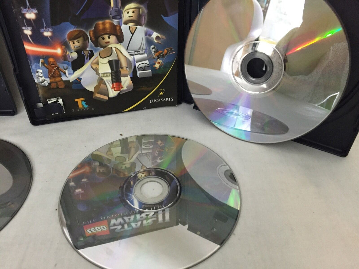 Another perspective of LEGO Star Wars game discs alongside their case, included in the 4 Devil May Cry 3 Dante's Awaken Transformers vintage magazine collection.