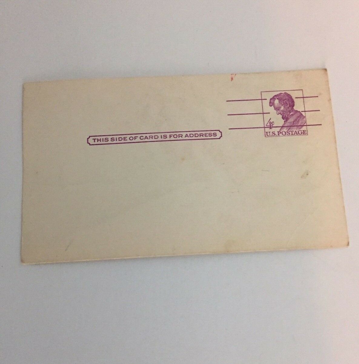 Image of the back of a RARE 4 Cents Abraham Lincoln United States Postal Card, featuring a space labeled for an address and a vintage postal stamp impression.