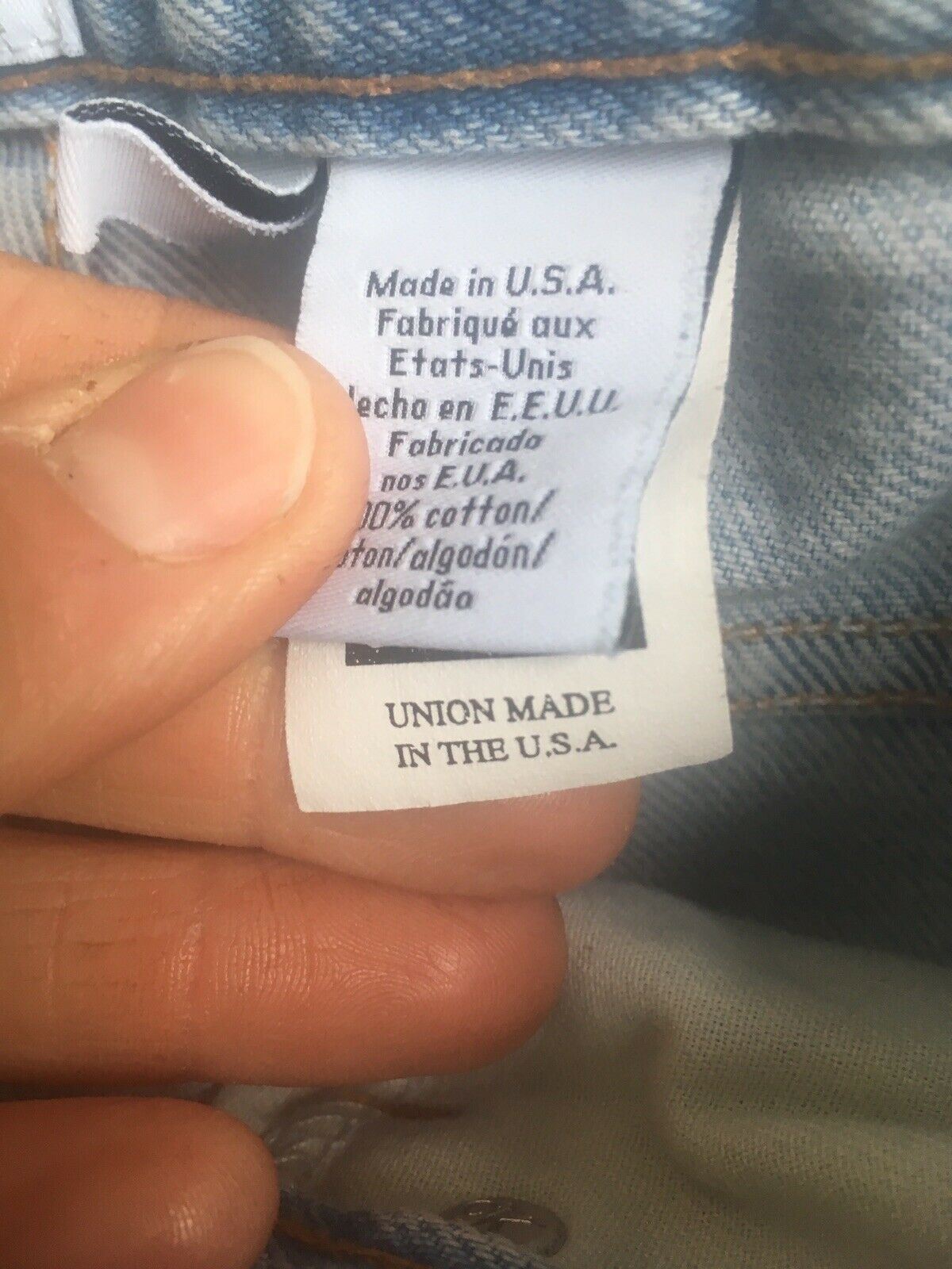 Tag inside Vintage 90s Calvin Klein High Rise Mom Jeans Light Blue Denim confirming 'Made in U.S.A.' along with fabric details and care instructions.
