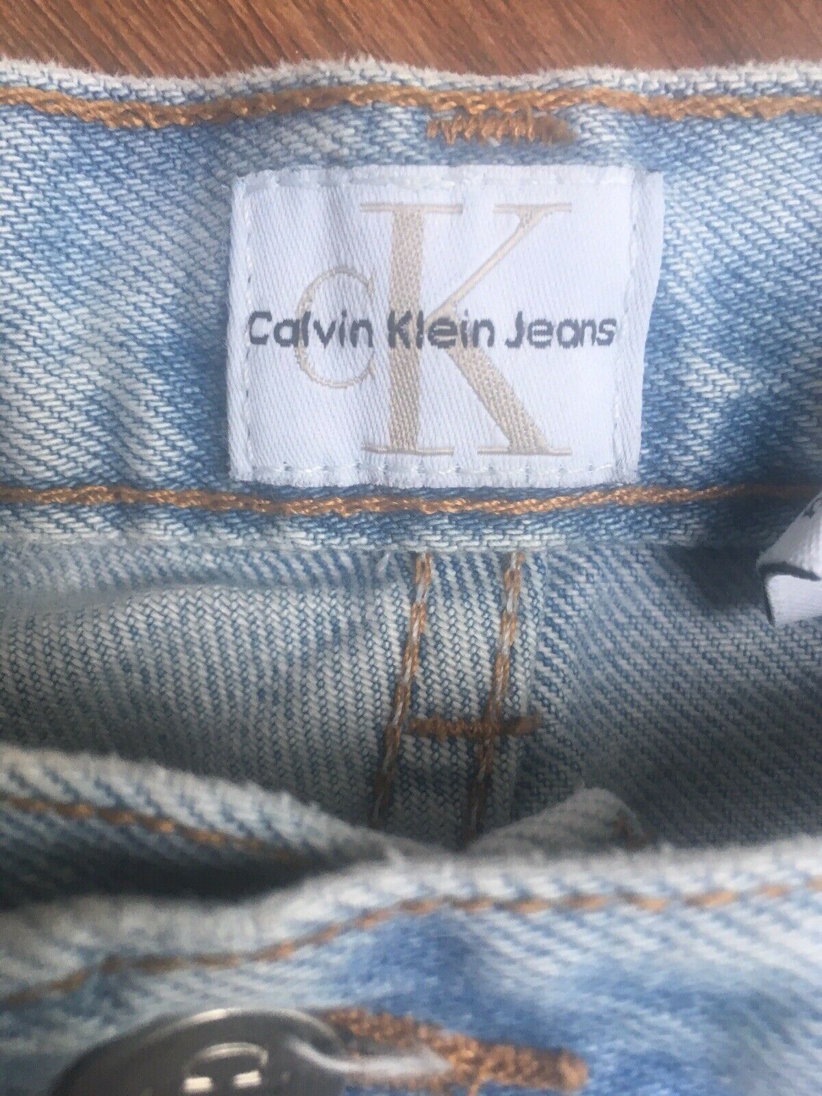Inside label of Vintage 90s Calvin Klein High Rise Mom Jeans featuring the Calvin Klein Jeans branding.