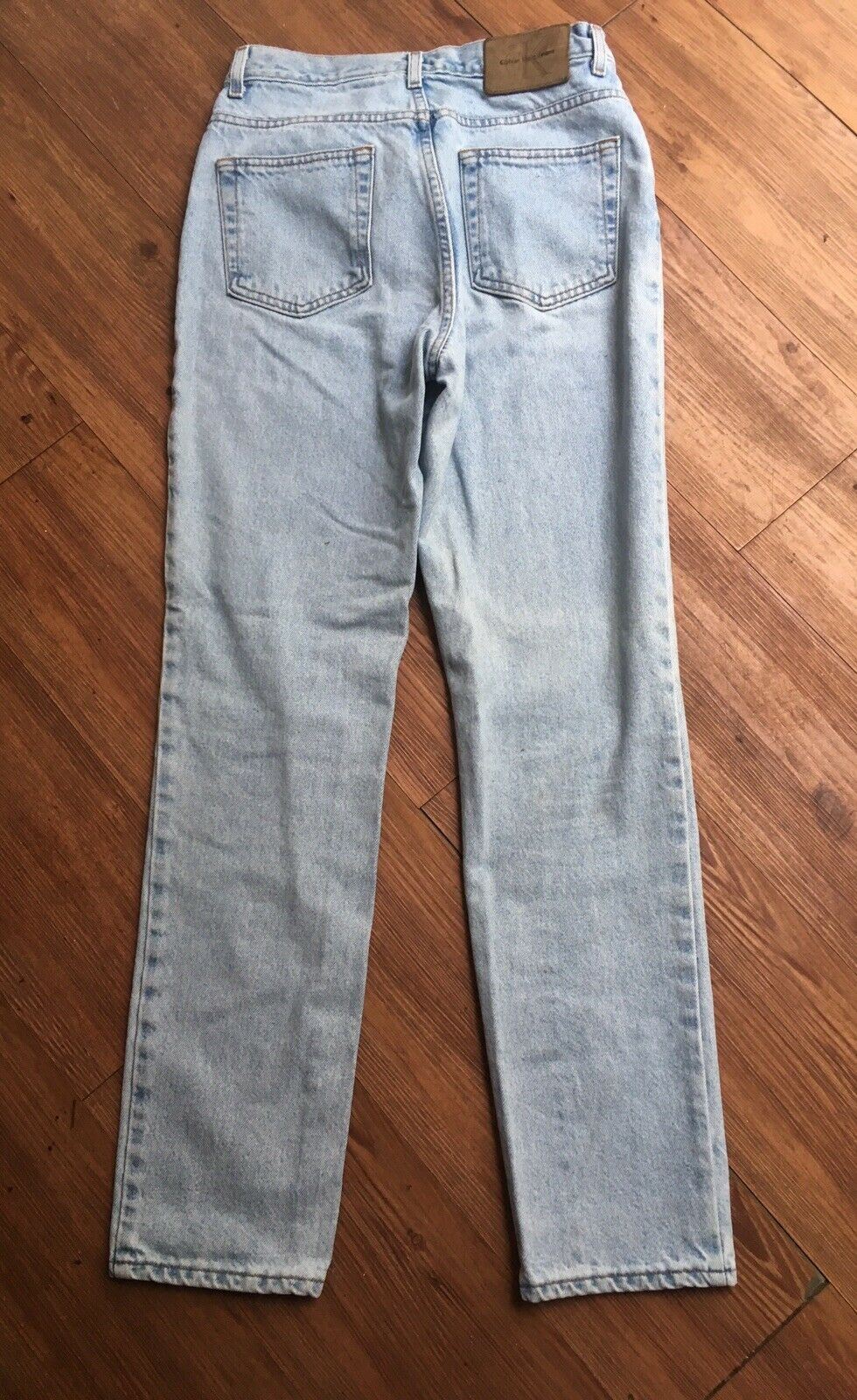 Back view of Vintage 90s Calvin Klein High Rise Mom Jeans displaying the straight leg design and pockets.