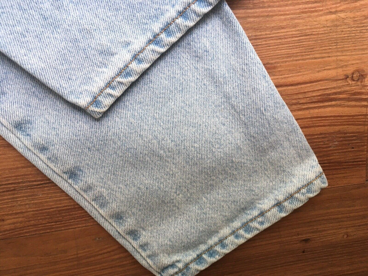 Hem detail of Vintage 90s Calvin Klein High Rise Mom Jeans showcasing the straight leg cut and light blue denim fabric.