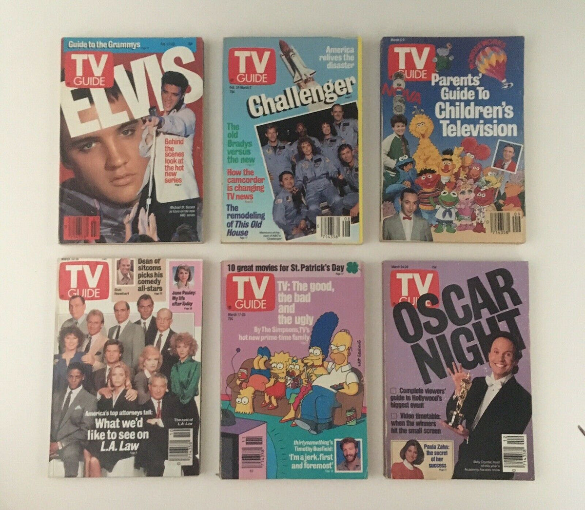 Collection of TV Guide magazines from 1990, featuring covers like Elvis, Challenger, Parents Guide to Children's Television, Oscar Night, highlighting notable television specials.