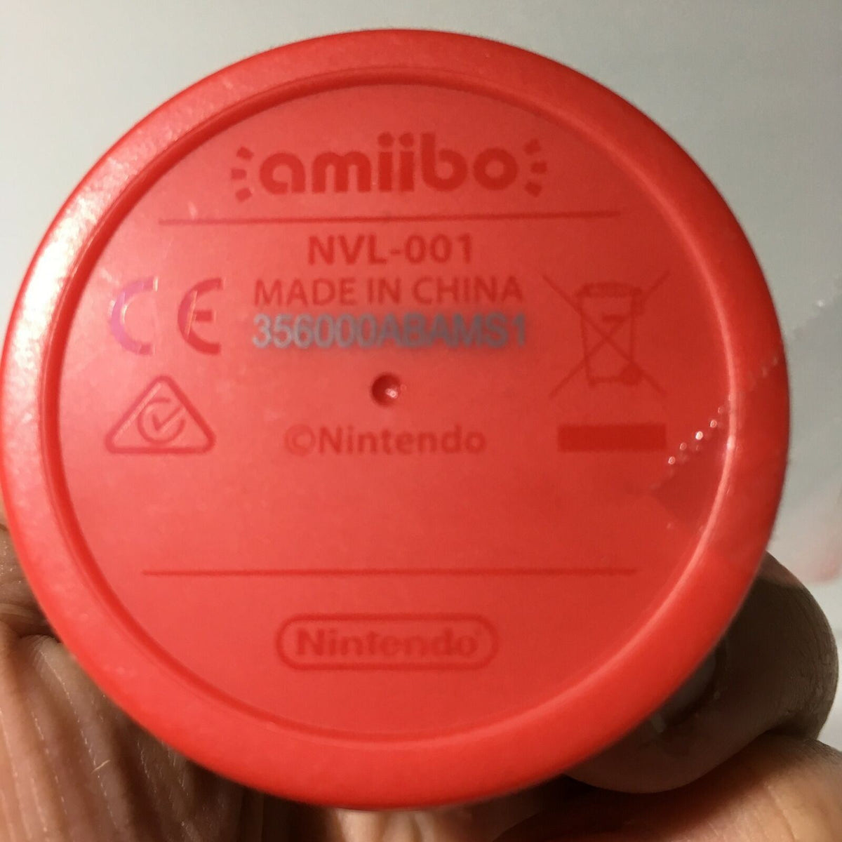 Bottom view of Nintendo Amiibo Diddy Kong, showing product details including model number NVL-001, made in China, and Nintendo branding. Perfect for collectors of Donkey Kong & Super Mario merchandise.