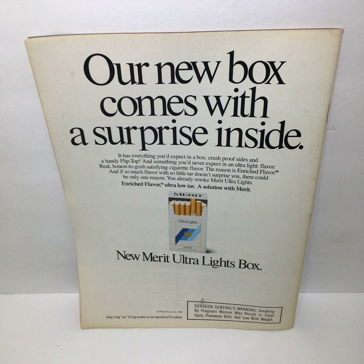 Back cover of vintage Time Magazine from April 11, 1988, featuring an advertisement for Merit Ultra Lights cigarettes with bold text stating, 'Our new box comes with a surprise inside.' Highlights the features of the cigarette box and includes a Surgeon General's warning.