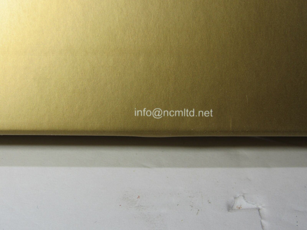 Close-up view of the packaging for Rare Kingfisher Airlines Luggage Tag First Class Metal Airplane, showcasing a shiny gold surface.