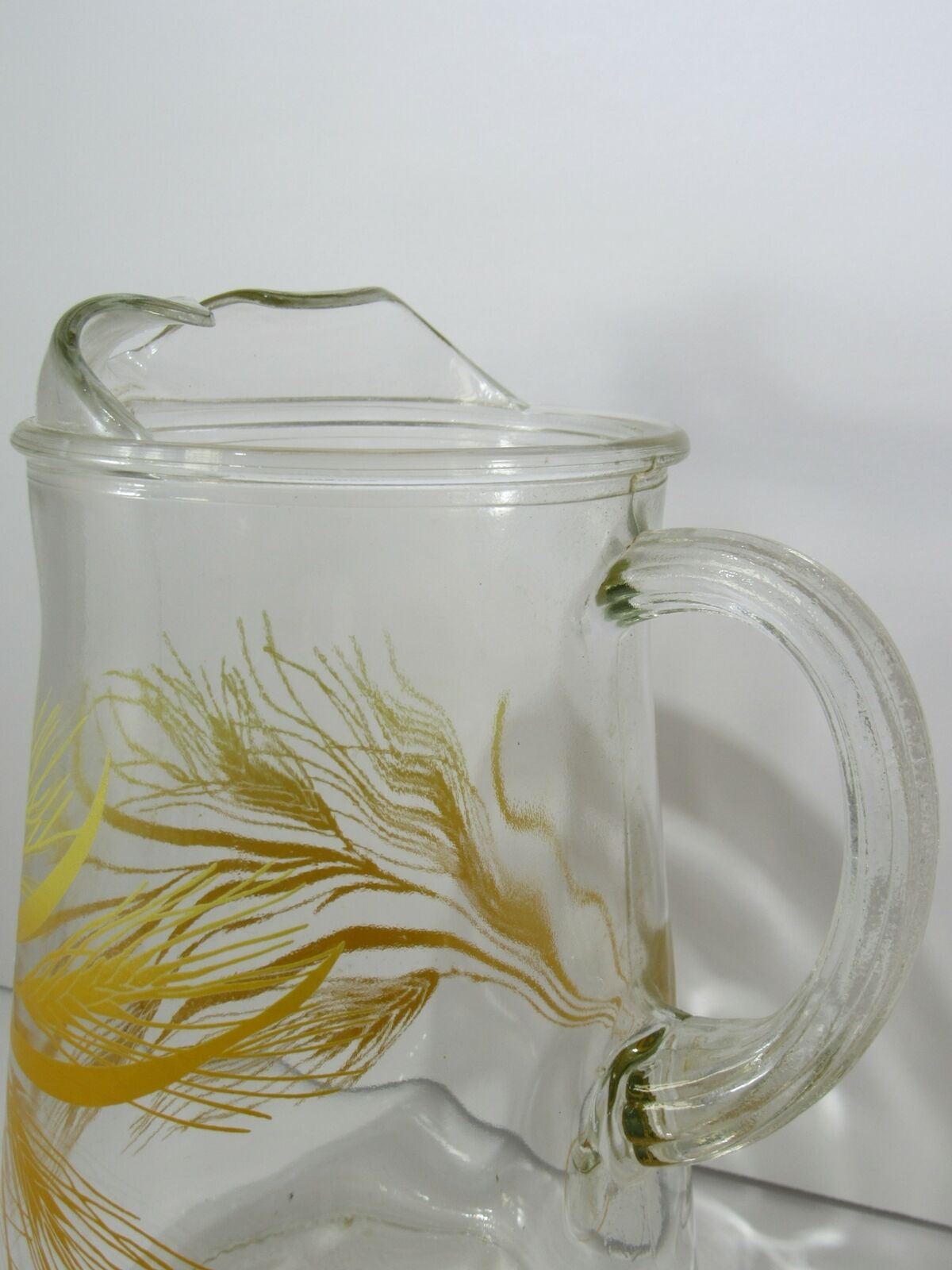 Close-up of the lip and handle of Vintage Libbey Golden Wheat Glass Pitcher, featuring intricate details and ice lip design.