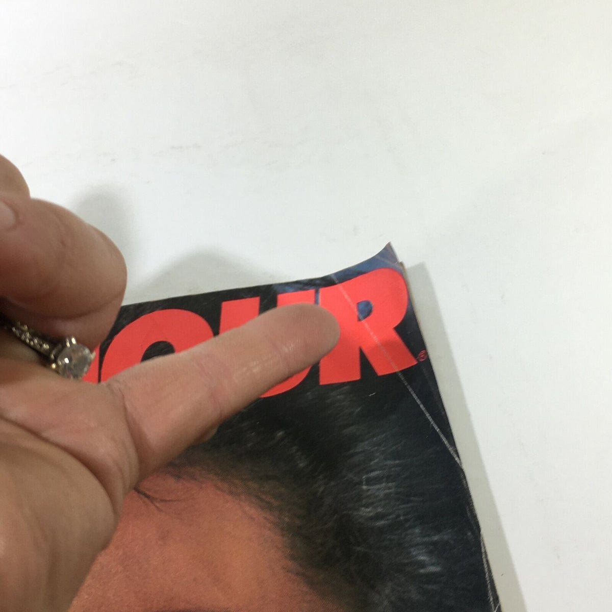 Detail of the cover of VTG Mademoiselle Magazine from November 1982, showcasing a finger pointing at the title, highlighting the 1980s fashion and culture.