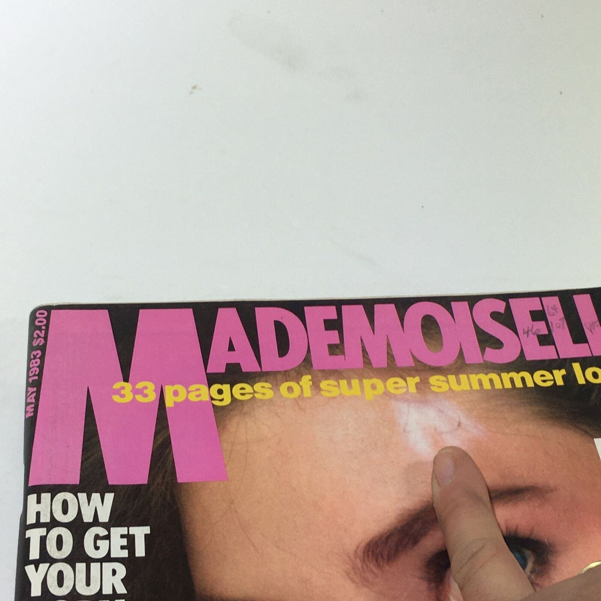 Close-up of the VTG Mademoiselle Magazine May 1983 cover displaying the title and features such as summer looks and beauty tips, showcasing vibrant colors and model's striking features.