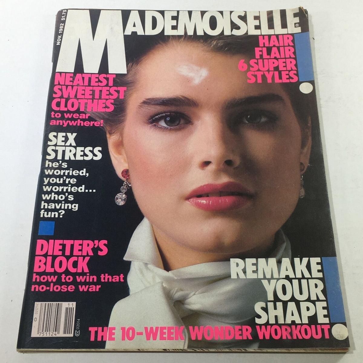 Cover of VTG Mademoiselle Magazine: November 1982 featuring a close-up of a model with bold makeup and earrings, highlighting fashion and beauty trends from the early 1980s.