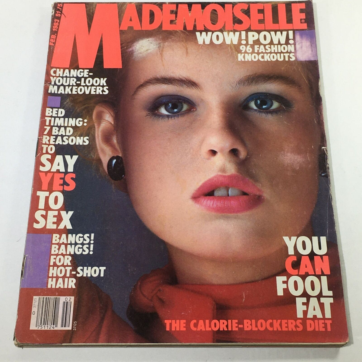 Cover of VTG Mademoiselle Magazine, February 1983 featuring bold typography and a stunning model with striking makeup. The cover showcases topics like fashion knockouts and personal narratives.