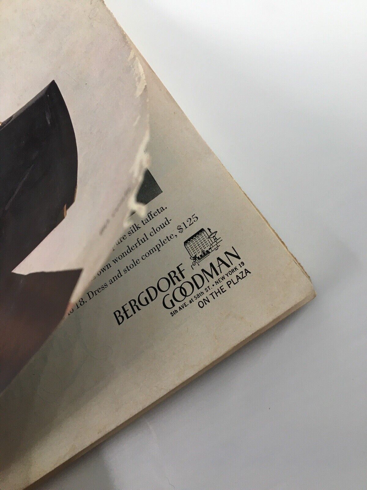Interior image of the Harper's Bazaar Magazine February 1953 displaying an advertisement for Bergdorf Goodman, highlighting vintage fashion and promoting a designer dress.