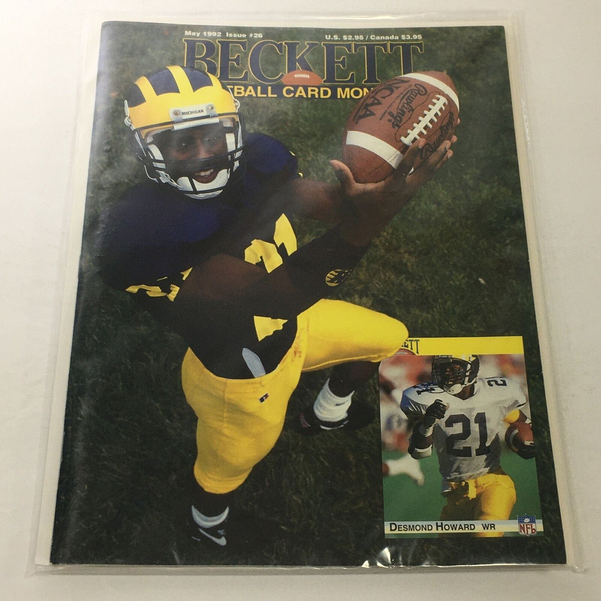 Beckett Football Card Monthly: May 1992 Issue #26 featuring NFL player Desmond Howard WR on the cover, showcasing him catching a football in a Michigan uniform.