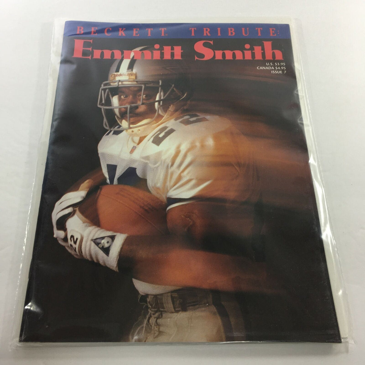Beckett Tribute: 1994 Issue #7 featuring Emmitt Smith, showcasing a rare photo of the football star in action with a dynamic pose, protected in plastic covering for preservation.