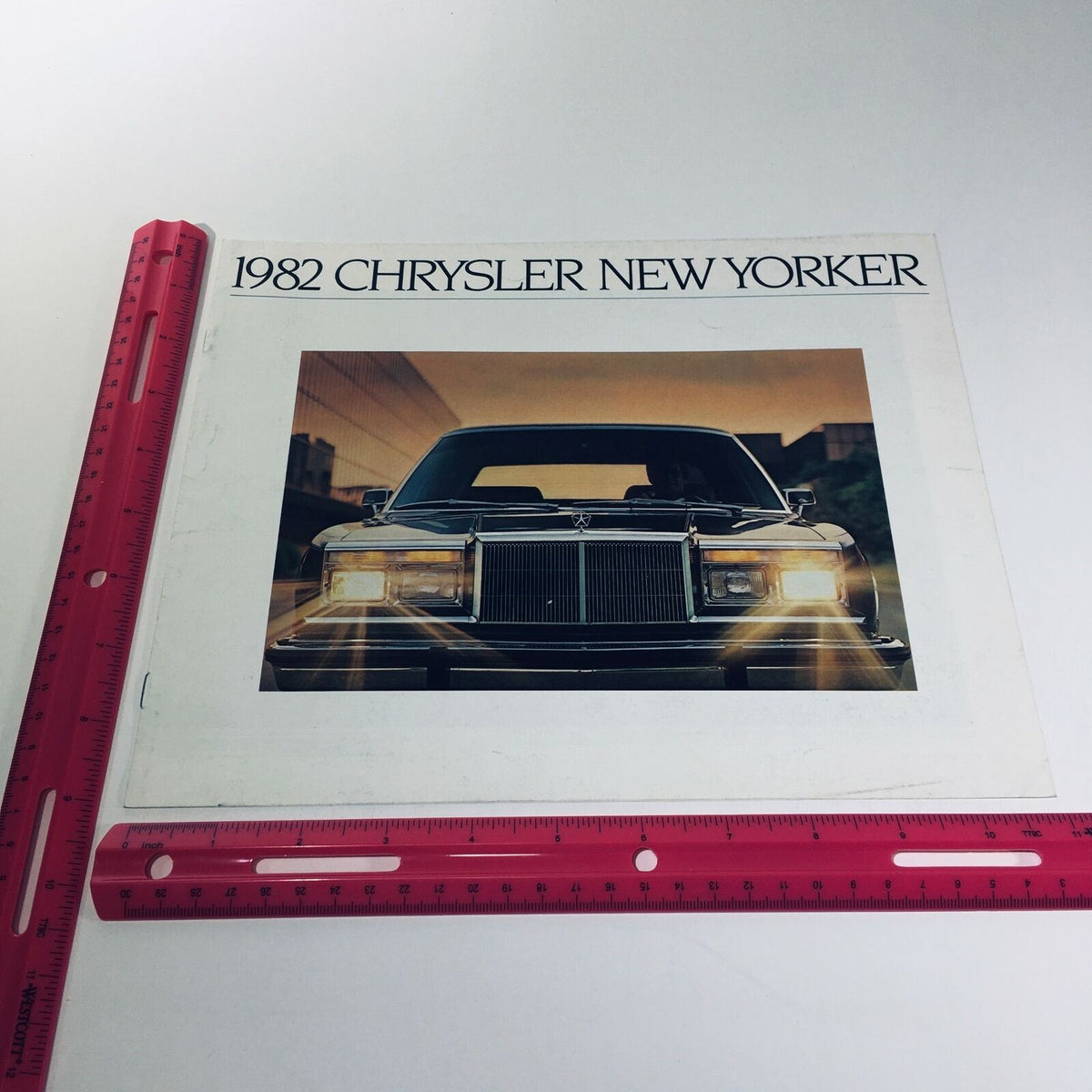 Cover of the 1982 Chrysler New Yorker V-8 OHV 6-cyl OHV 8/81 Car Sale Brochure displaying the New Yorker car with a striking design and elegant presentation.