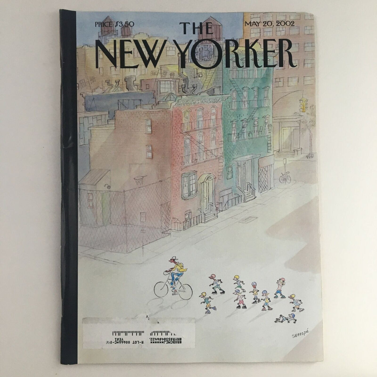 The New Yorker Magazine cover from May 20, 2002, featuring an illustration by Jean-Jacques Sempé, depicting a colorful downtown scene with children biking and playing.