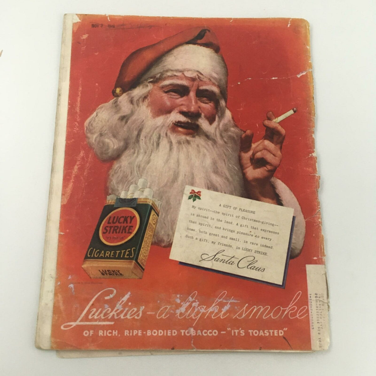Cover of an advertisement magazine from 1946 featuring Santa Claus smoking a cigarette and promoting Lucky Strike cigarettes.