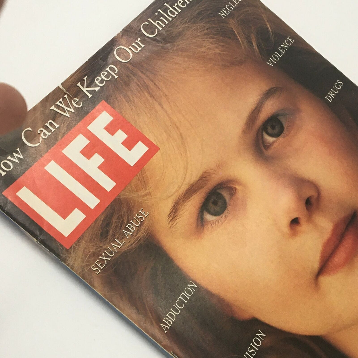 Close-up view of the Life Magazine cover from July 1995, titled 'How Can We Keep Our Children Safe?' showcasing a young girl's portrait with highlighted concerns related to child safety.