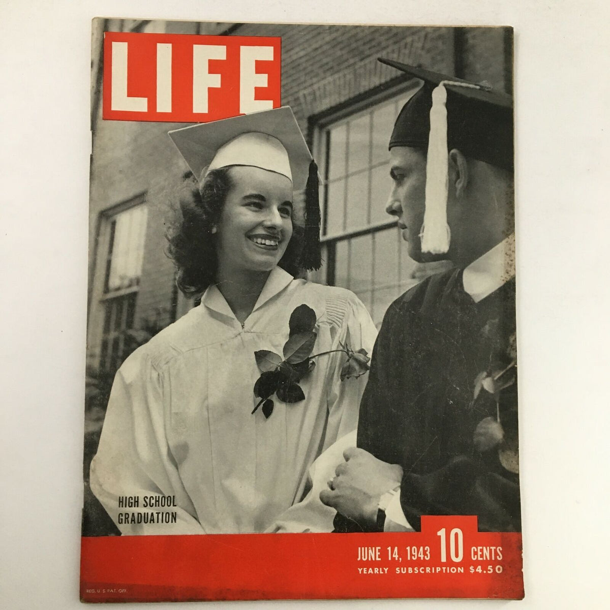 Cover of Life Magazine June 14, 1943 depicting a high school graduation with a smiling female graduate in a cap and gown and a male student in graduation attire.