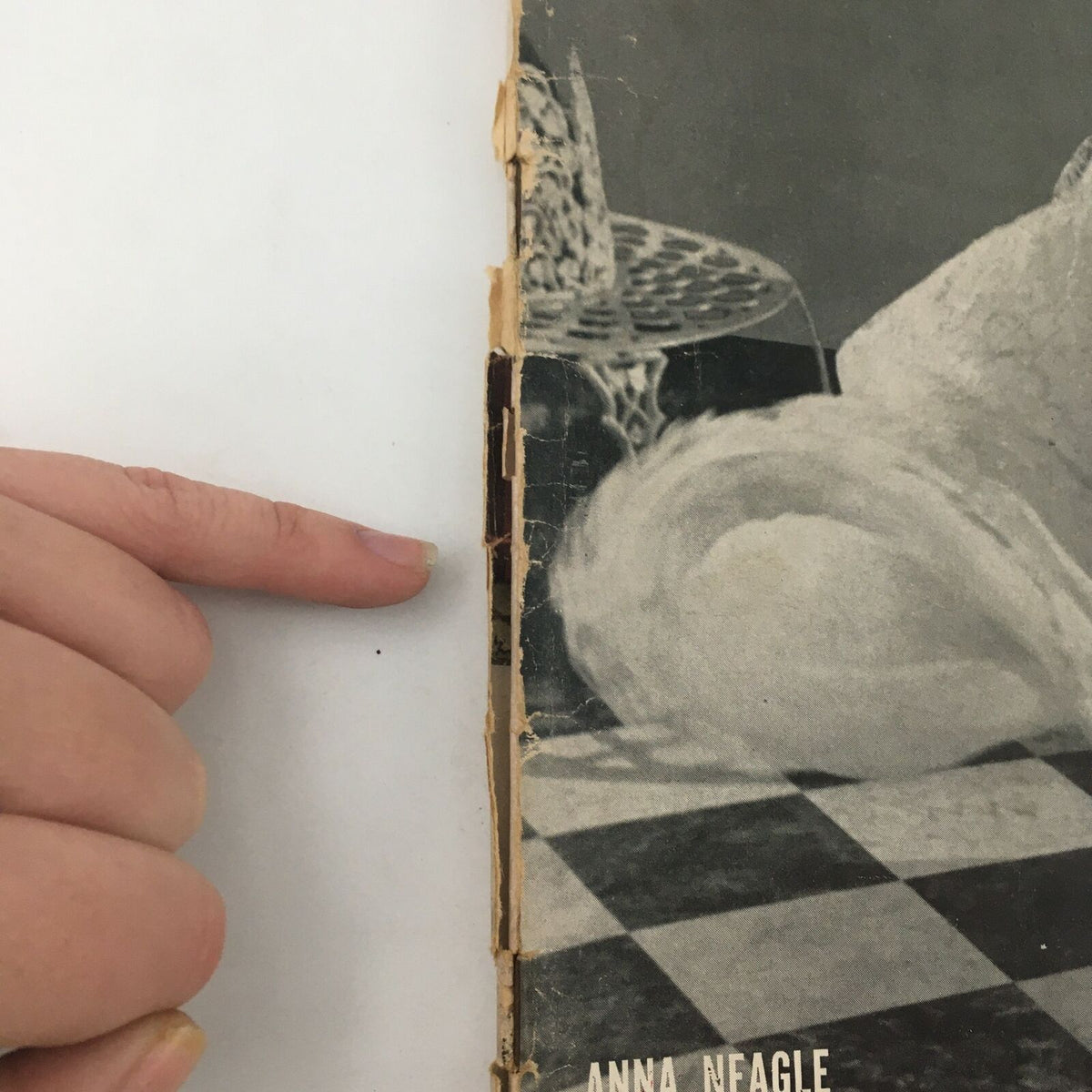 Close-up view of the edge of a vintage Life Magazine featuring film actress Anna Neagle from April 8, 1940, highlighting wear and tear on the spine.