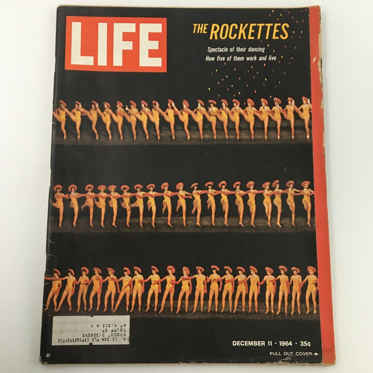 Cover of VTG Life Magazine December 11, 1964 featuring The Rockettes, showcasing a spectacular dancing performance with the dancers lined up in vibrant costumes, highlighting a memorable era in entertainment.