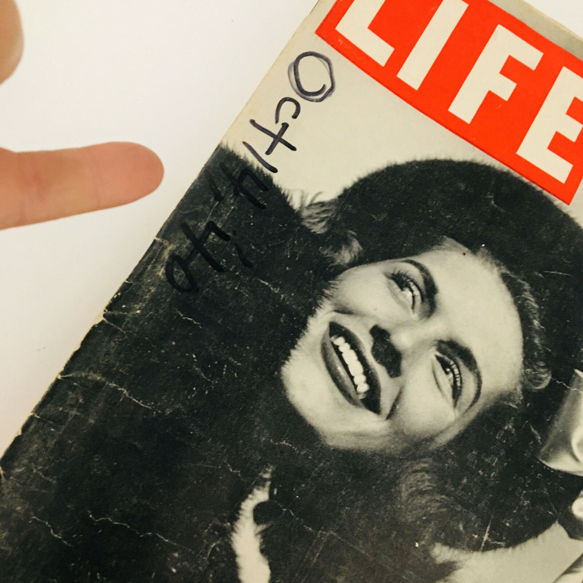 Close-up of the cover of VTG Life Magazine October 14 1940 showcasing a smiling lady and details of the magazine's title.