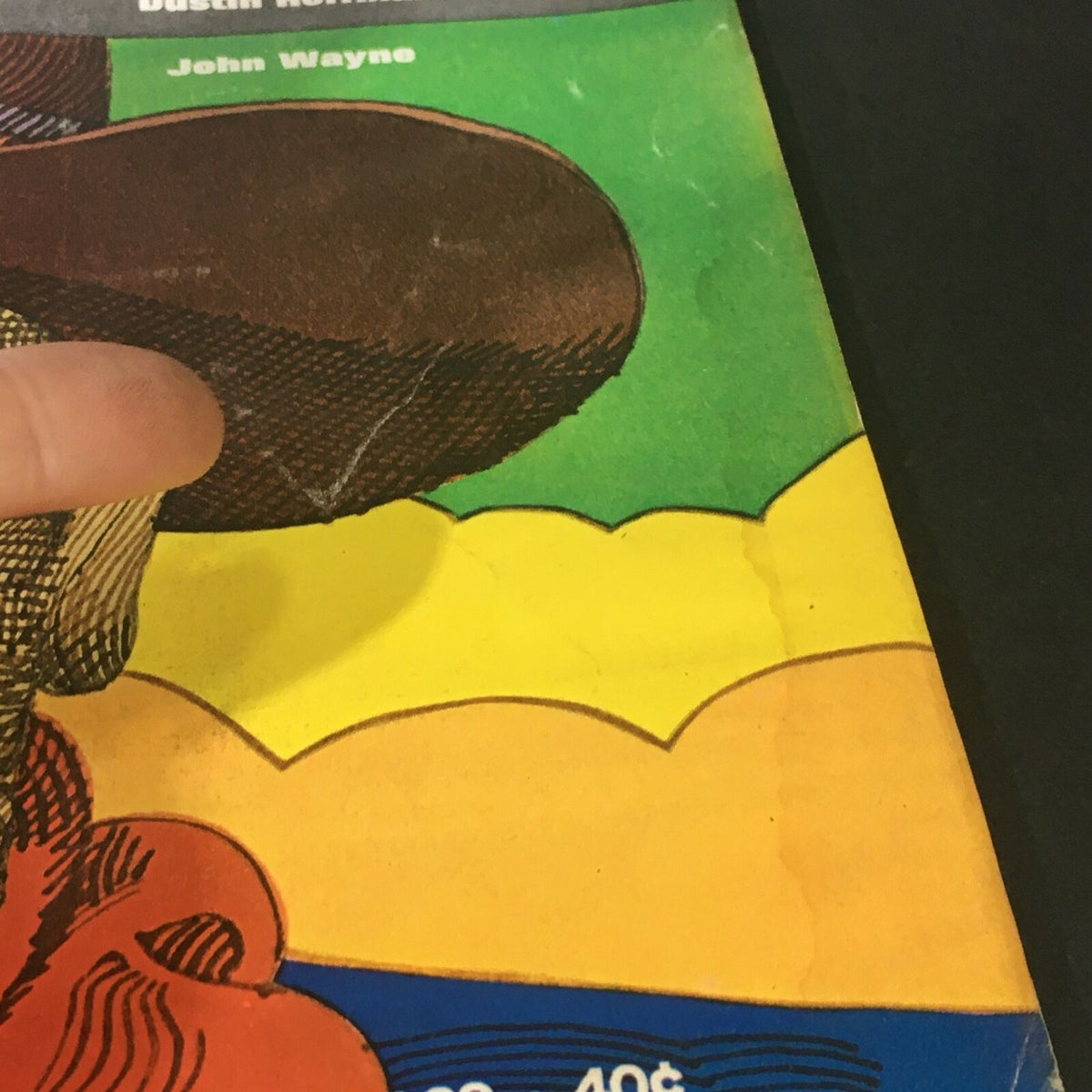 Close-up showing the corner of the VTG Life Magazine July 11, 1969, highlighting wear and tear, focusing on John Wayne's illustration.