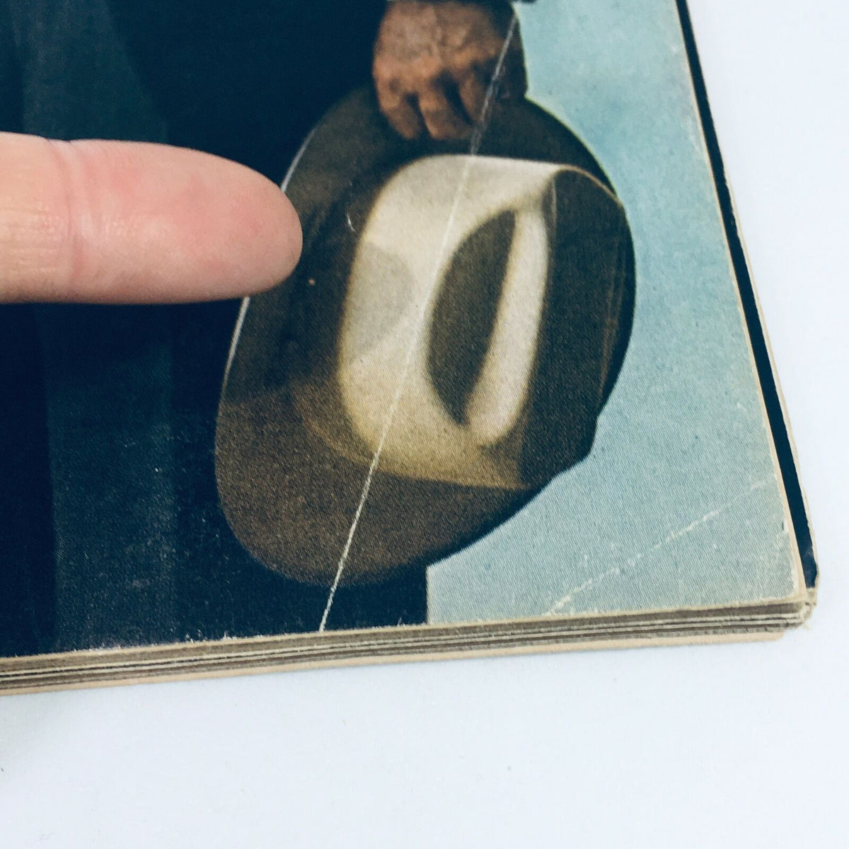 Close-up detail of the cover of the Vintage Life Magazine from November 24, 1967, showcasing a character holding a hat, connected to the title 'Why John F. Kennedy Went To Texas?'.