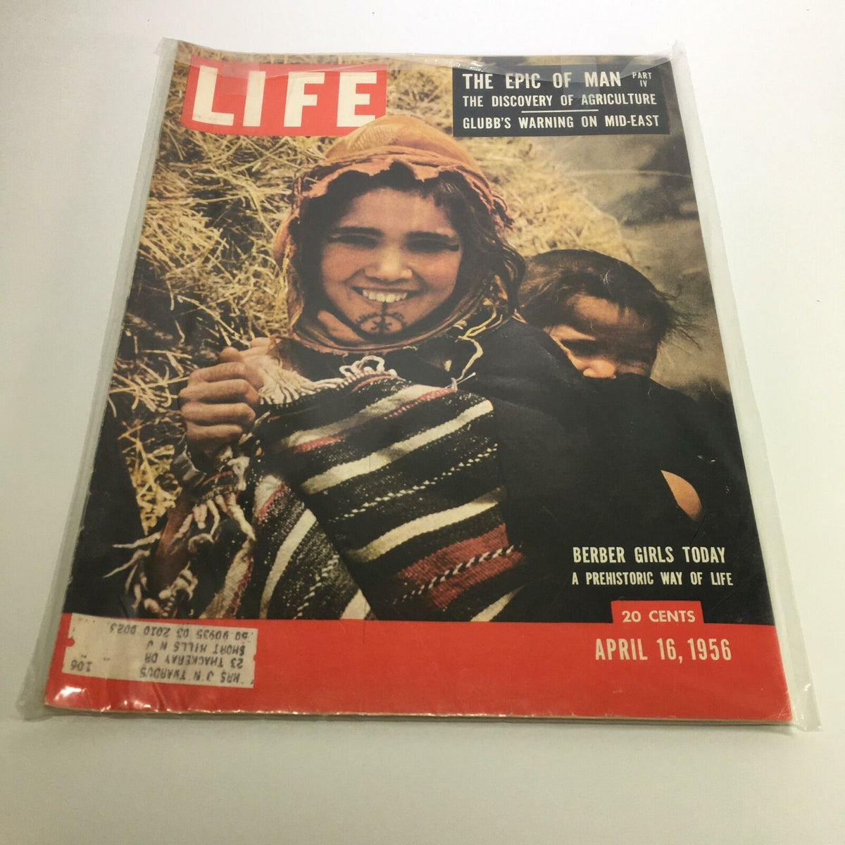Cover of Life Magazine dated April 16, 1956, featuring the article 'Berber Girls Today: A Prehistoric Way of Life', showcasing an image of a smiling Berber girl in traditional attire against a backdrop of straw.