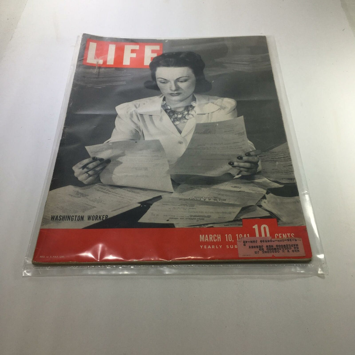 VTG Life Magazine cover from March 10, 1941, titled 'Washington Worker', showcasing a woman reviewing documents amid a pile of papers, reflecting the historical context of early 1940s America.