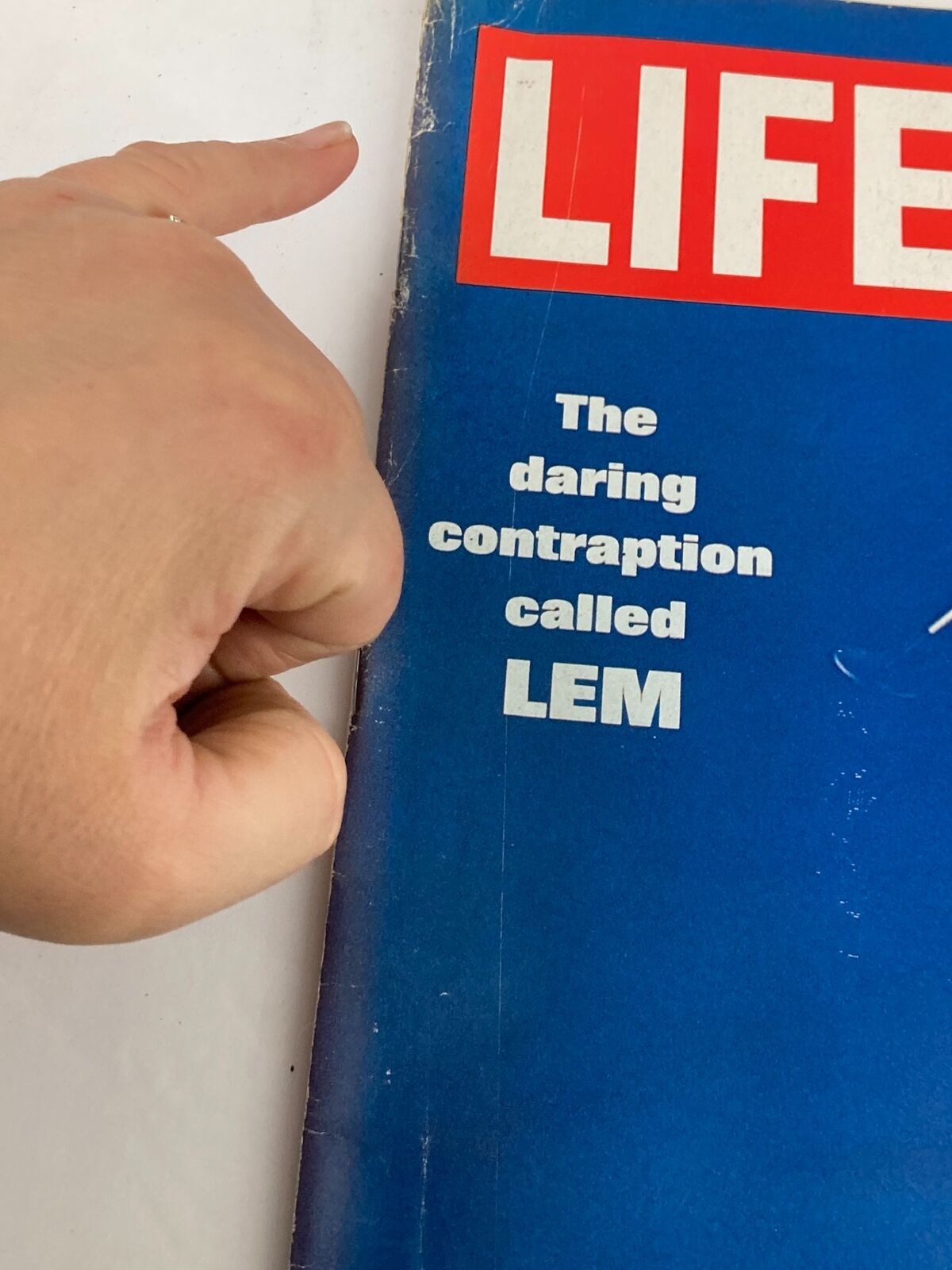 Close-up view of the cover of VTG Life Magazine from March 14, 1969, highlighting the text 'The daring contraption called LEM', showcasing signs of wear and vintage appeal.