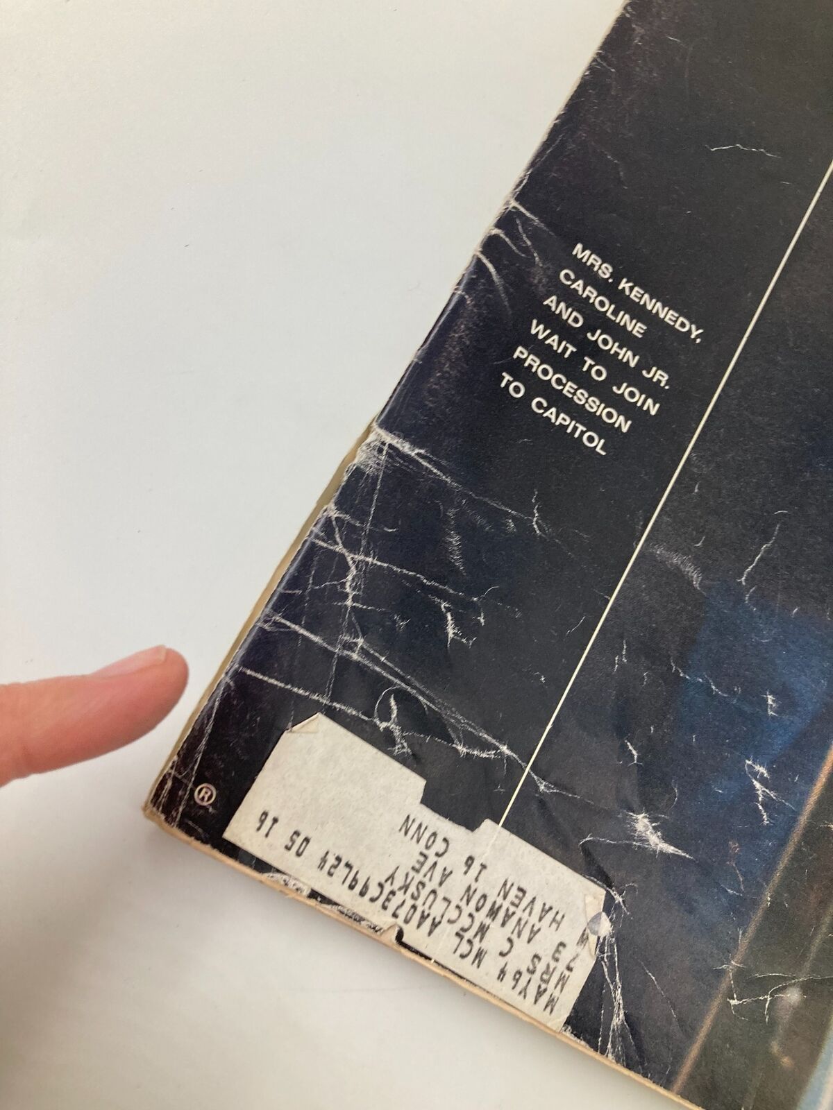 Close-up of the side of Vintage Life Magazine from December 6 1963, highlighting the cover text that reads 'Mrs. Kennedy, Caroline and John Jr. wait to join procession to Capitol'.