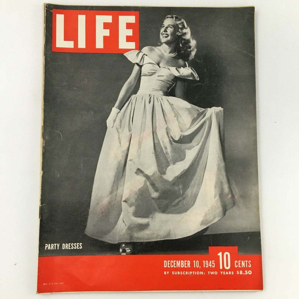 Cover of VTG Life Magazine from December 10, 1945 featuring a model in an elegant party dress, showcasing the fashion and style of the post-war era.