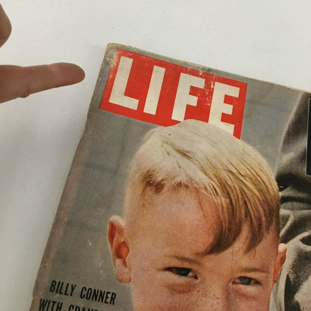 Close-up view of the cover of VTG Life Magazine August 29 1955 featuring the title 'LIFE' and a boy named Billy Conner, showcasing vintage magazine details.