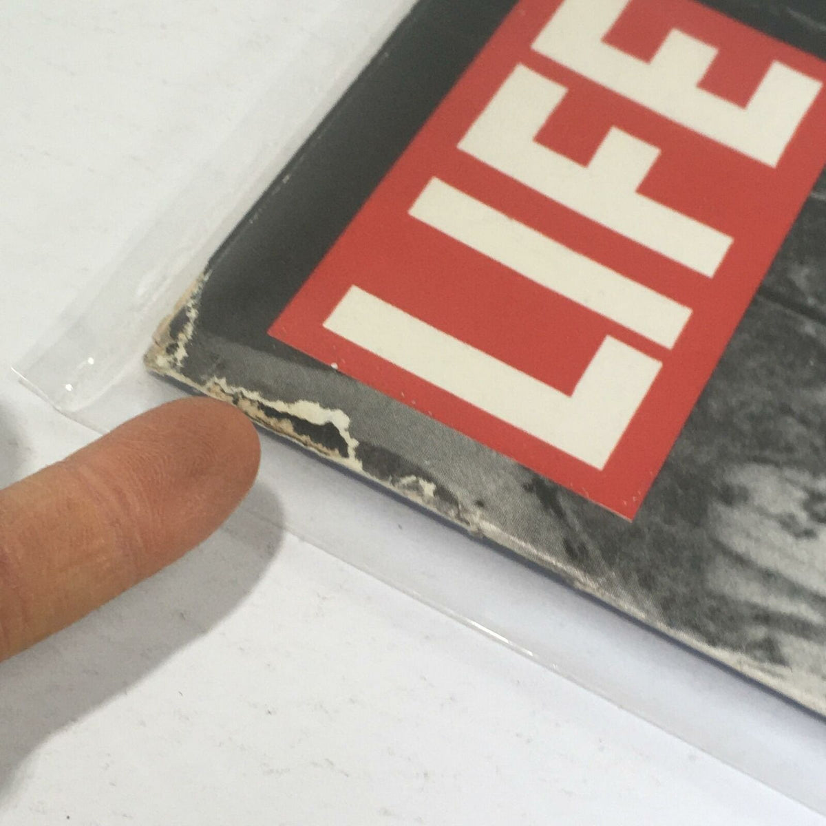 Close-up view of the corner of a vintage Life Magazine from November 29, 1968, highlighting the wear on the cover and the iconic 'LIFE' logo. This magazine features a cover story about the Soviet T55 Tank and Russia in the Middle East.