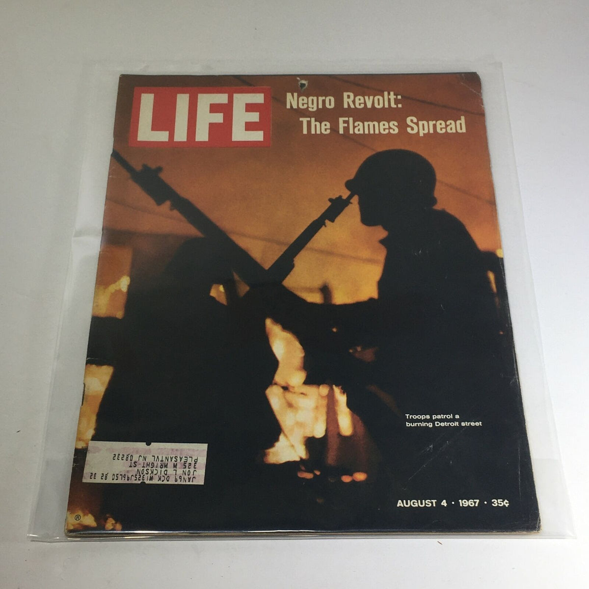 Vintage Life Magazine cover from August 4, 1967 titled 'Negro Revolt: The Flames Spread' featuring silhouettes of soldiers guarding a burning street, reflecting a significant moment in American history.
