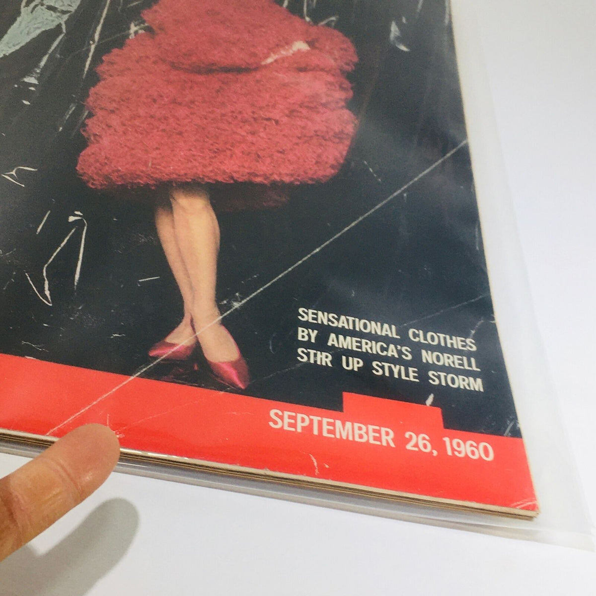 Detailed view of the cover of VTG Life Magazine dated September 26, 1960, with a focus on the sensational clothing by Norell and model's vibrant red attire.