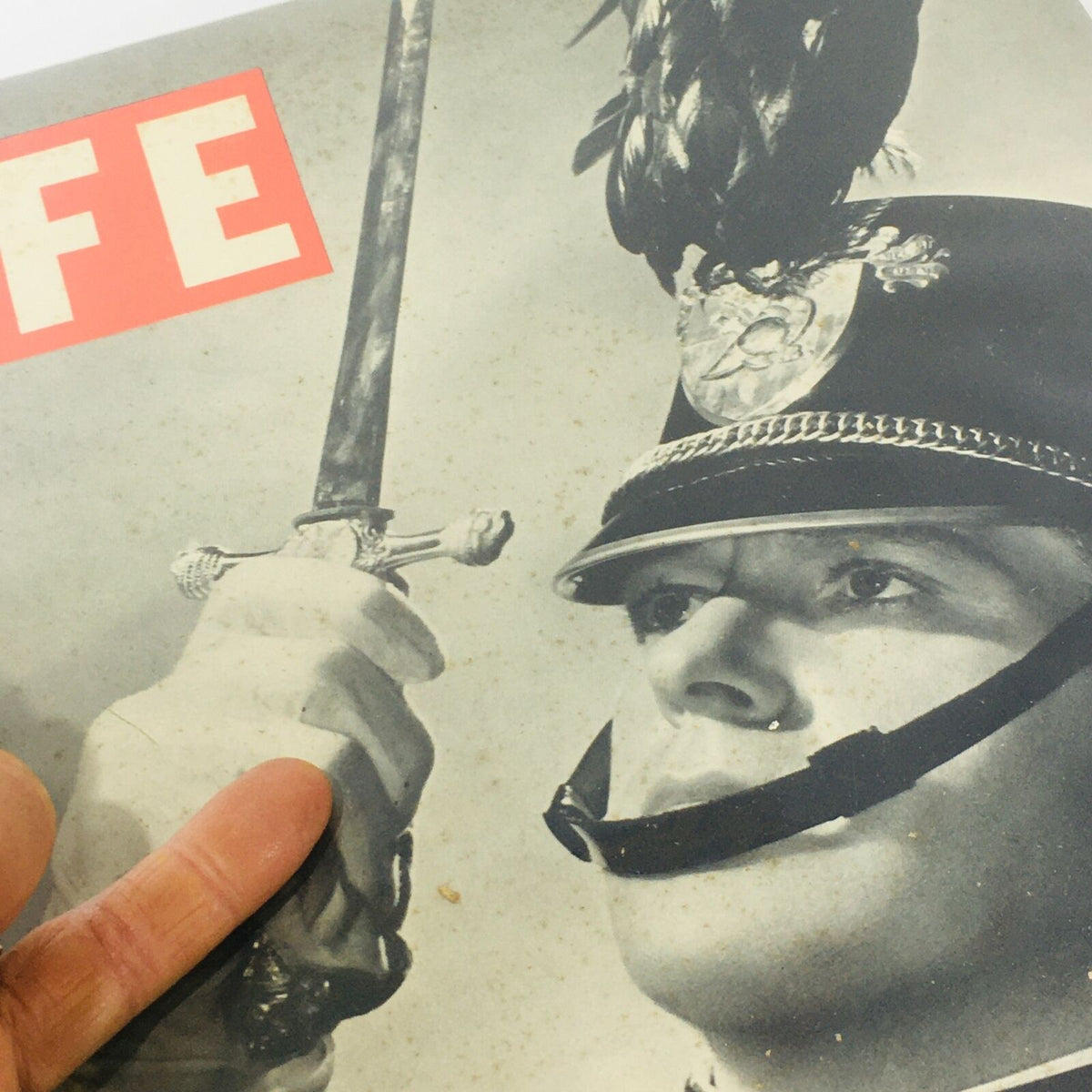 Close-up view of the cover of Vintage Life Magazine: September 27 1937 showcasing Nelson Eddy, capturing the intricate details of the military uniform and sword.
