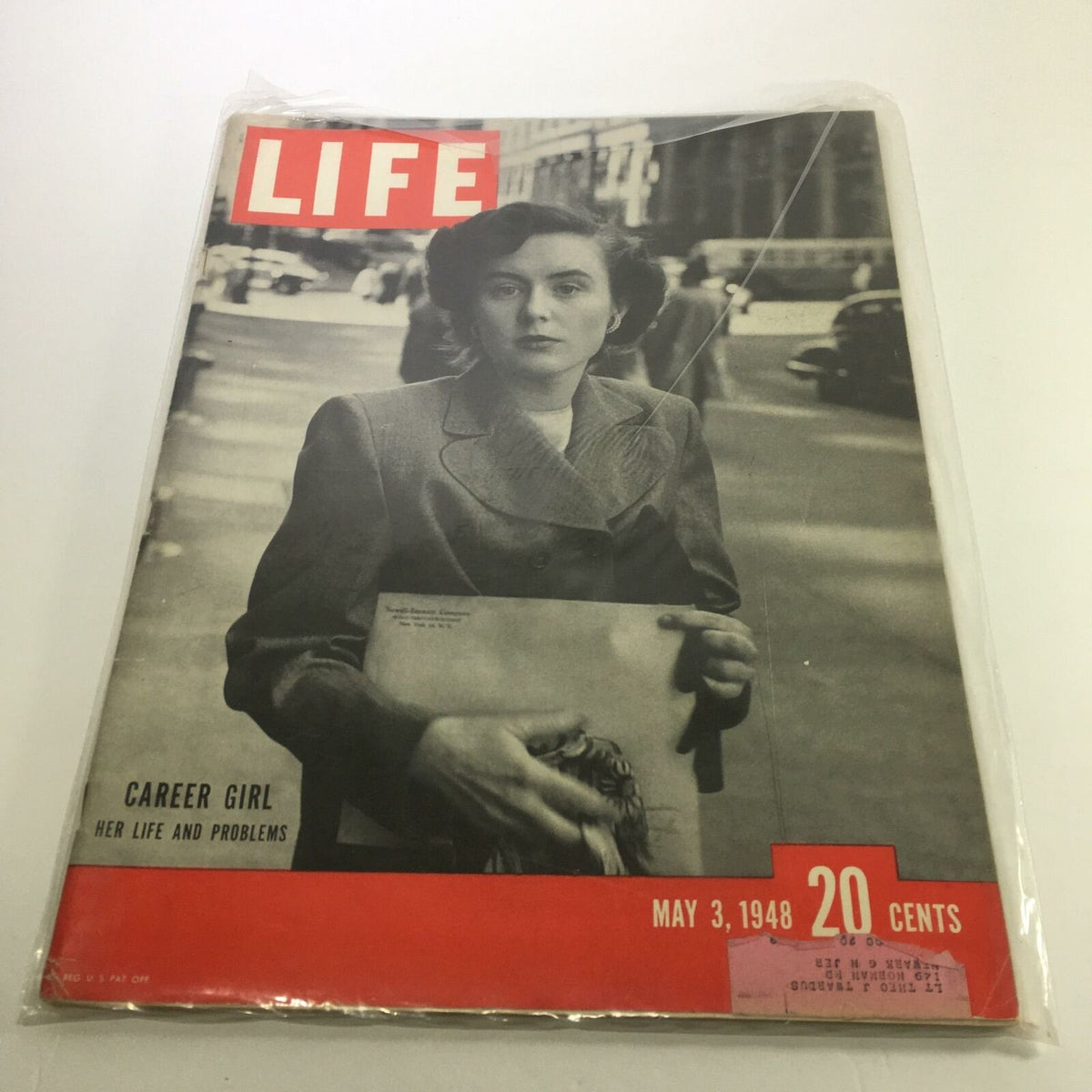 Life Magazine cover from May 3, 1948, featuring the title 'Career Girl: Her Life & Problems,' showcasing a woman in a stylish gray suit, holding papers, set against a street scene.