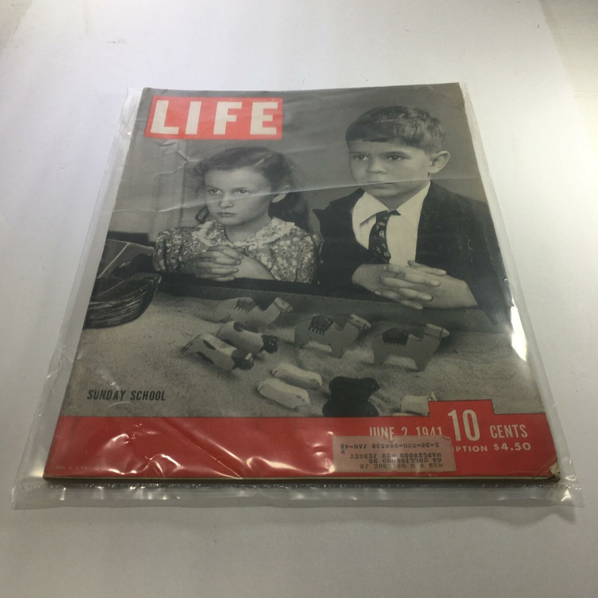 Vintage Life Magazine from June 2, 1941 featuring a cover story about Sunday School, showcasing two children in thoughtful expressions with toys in the foreground. A nostalgic piece for collectors and enthusiasts, highlighting early 1940s American culture.