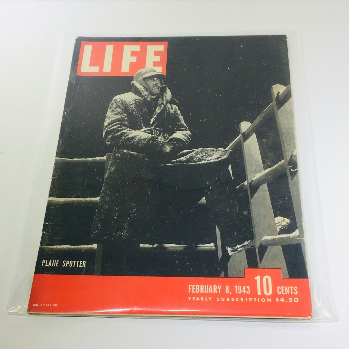 Vintage Life Magazine Cover - February 8, 1943, featuring the 'Plane Spotter' article. The cover depicts a man in winter clothing standing on a snowy lookout, capturing the essence of WWII aviation and historical events.