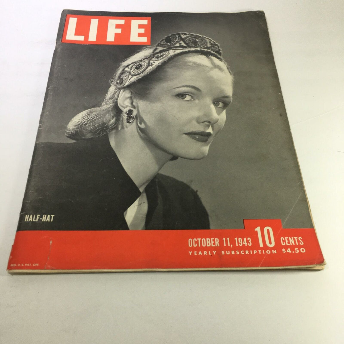 Life Magazine: October 11, 1943 - Half Hat cover featuring a woman in a vintage half hat, showcasing iconic early 1940s fashion and photography.